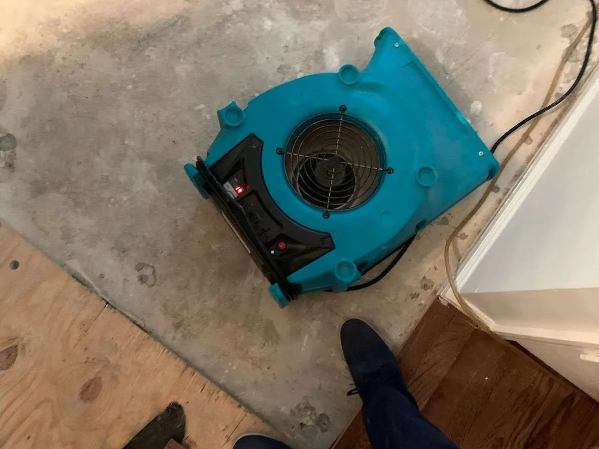 Air mover drying subfloor during Leak Detection & Repair in New Cumberland